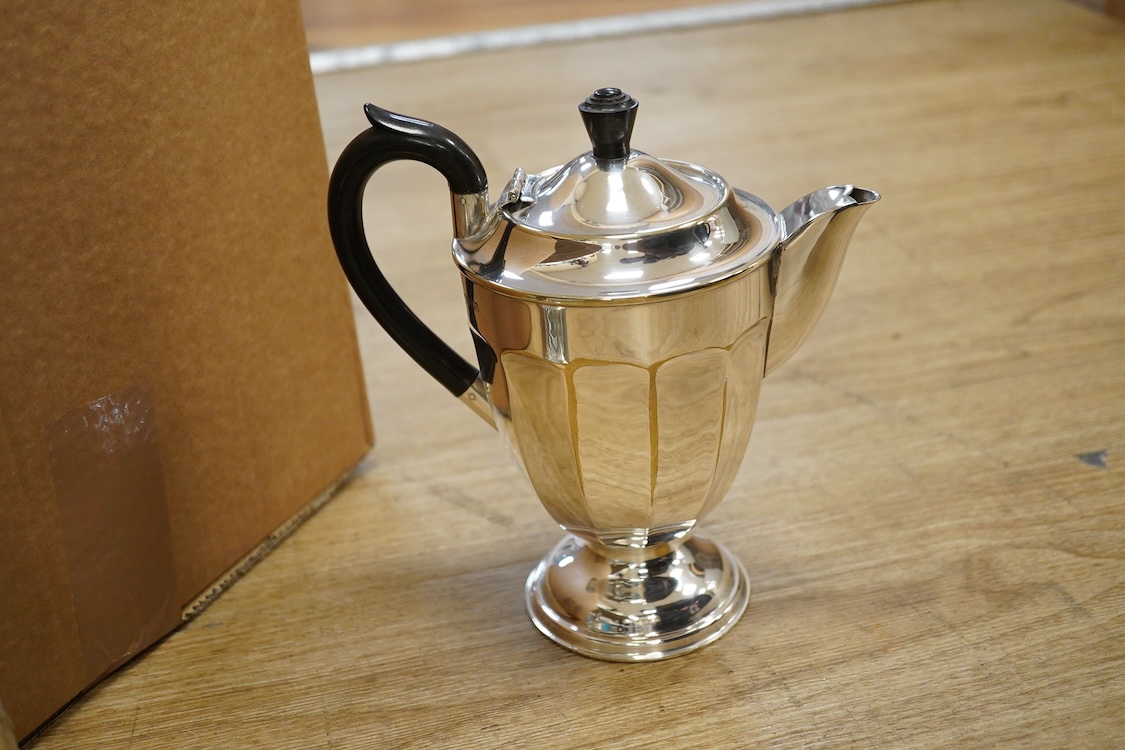 Assorted plated wares including a pair of candlesticks and a casserole dish.
